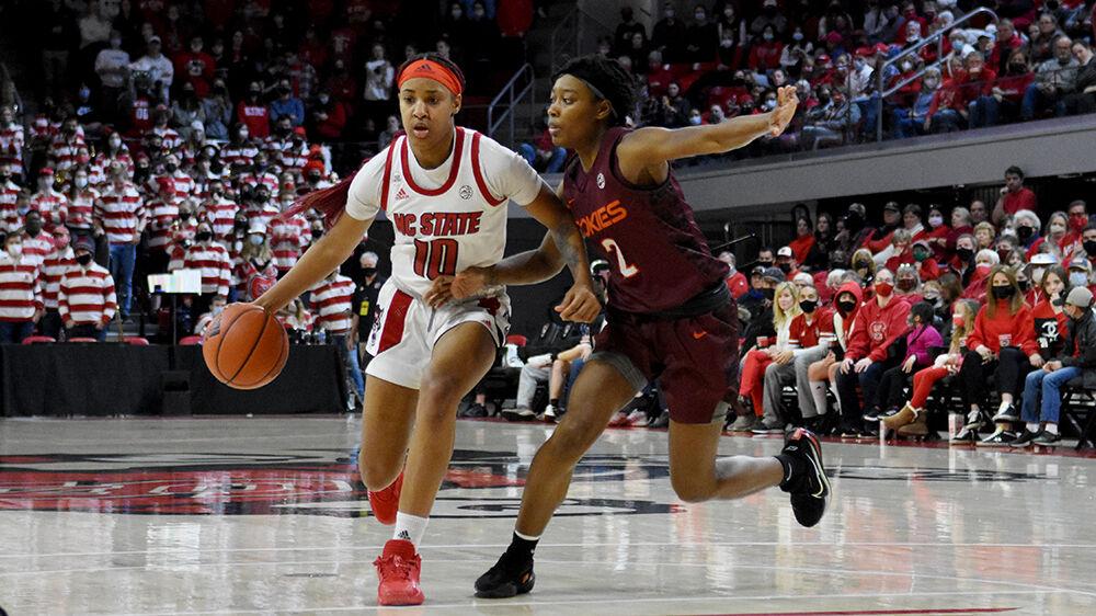 Freshman guard Aziaha James dribbles down the court past a Virginia Tech defender at Reynolds Coliseum on Sunday, Jan. 23, 2022. NC State beat Virginia Tech 51-45.