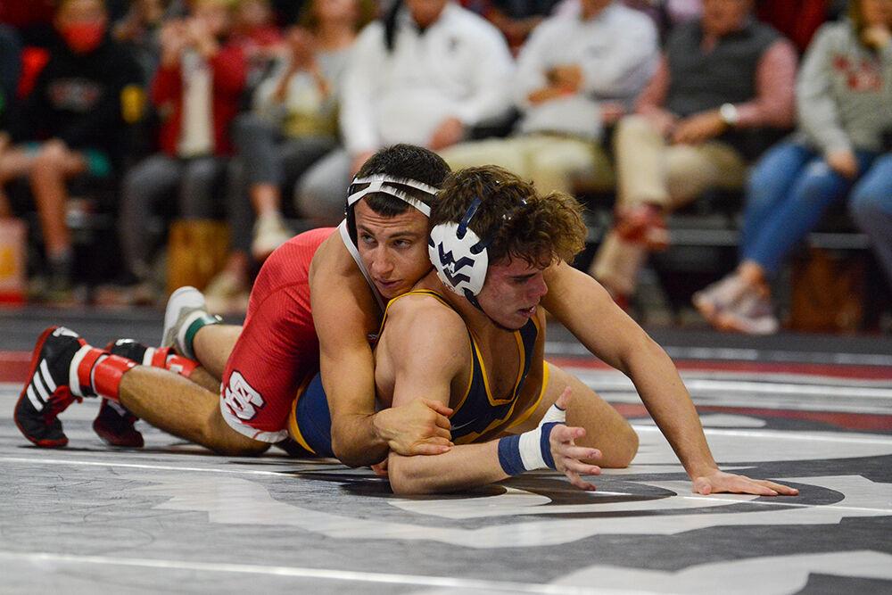 Redshirt sophomore Jakob Camacho fights to maintain control during the NC State match against West Virginia on Sunday, November 21, 2021 in Reynolds Coliseum. Camacho won his individual match against the Mountaineers 14-4. The Pack beat the Mountaineers 34-6.