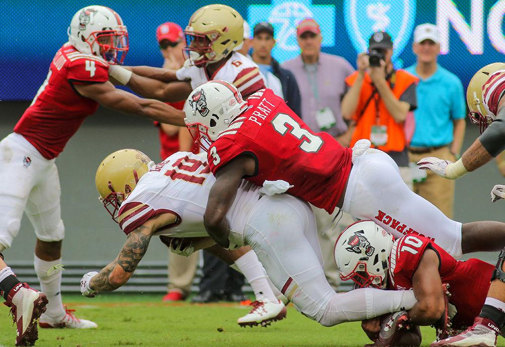 Graduate linebacker Germaine Pratt comes from behind to get the tackle on Boston College running back Ben Glines. Pratt had a major day with 1.5 tackles for a loss, the sack, and a forced fumble that he recovered. NC State survived a late Boston College resurgence for a 28-23 win on Saturday, Oct. 6 in Carter-Finley Stadium.