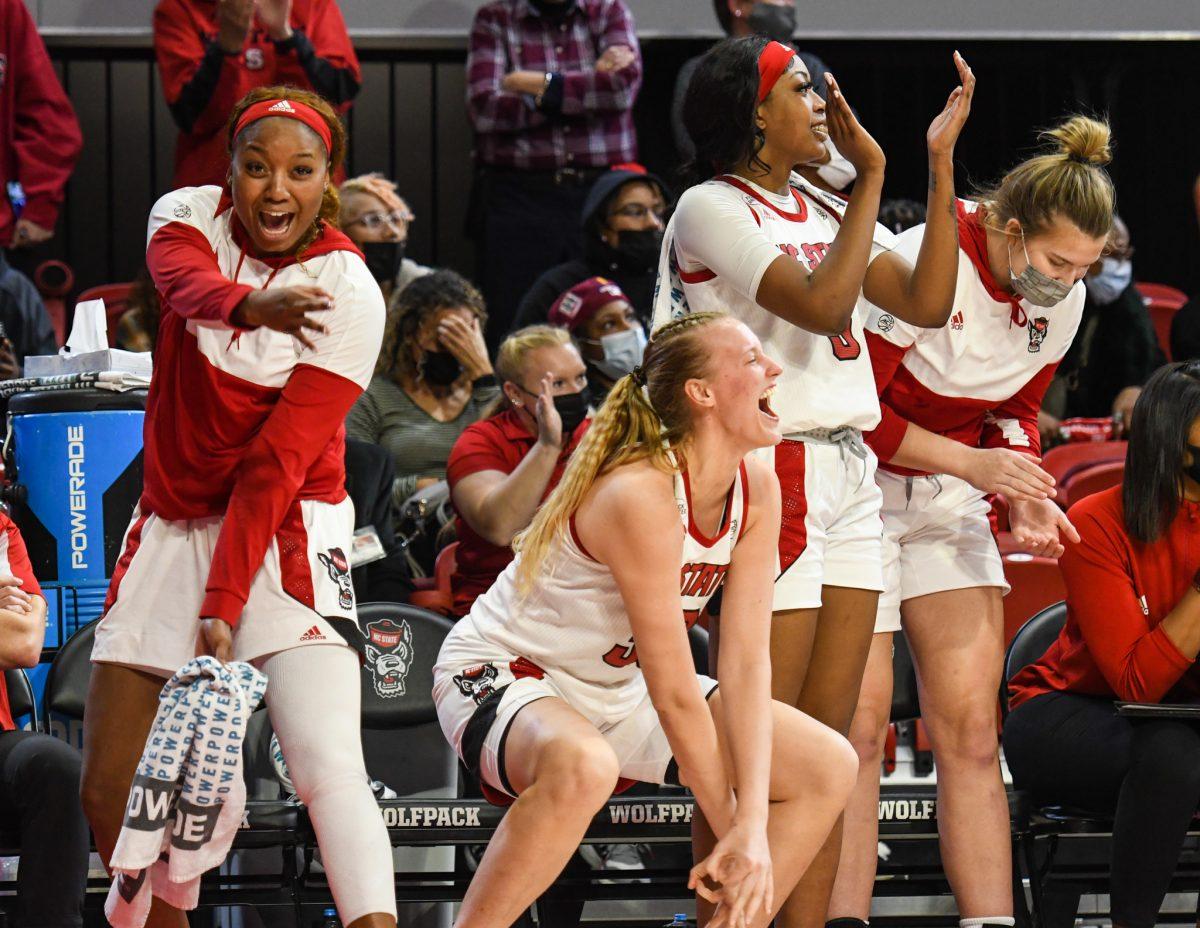The NC State Women's Basketball team celebrates a three pointer in the last quarter of the game versus the UNC Tar Heels on Thursday, Jan. 6, 2021 in Reynolds Coliseum. The Wolfpack beat the Tar Heels 72-45.