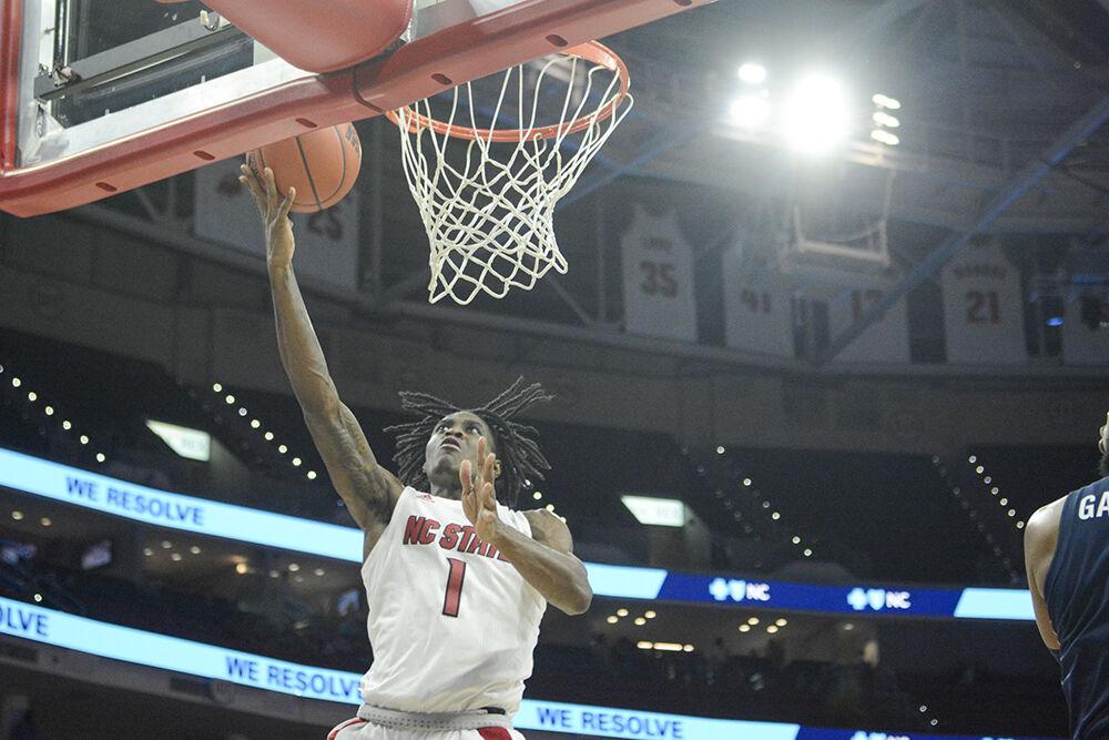 Redshirt-sophomore guard Dereon Seabron makes a layup&#160;in the men's basketball home game against Virginia at PNC Arena on January 22, 2022. Seabron had 13 points, five assists and six rebounds. NC State beat Virginia 77-63.&#160;