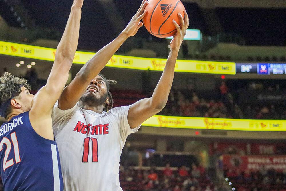Sophomore forward Jaylon Gibson attempts a layup in the men's basketball home game against Virginia at PNC Arena on January 22, 2022. Gibson had one rebound throughout the game. NC State beat Virginia&#160;77-63.