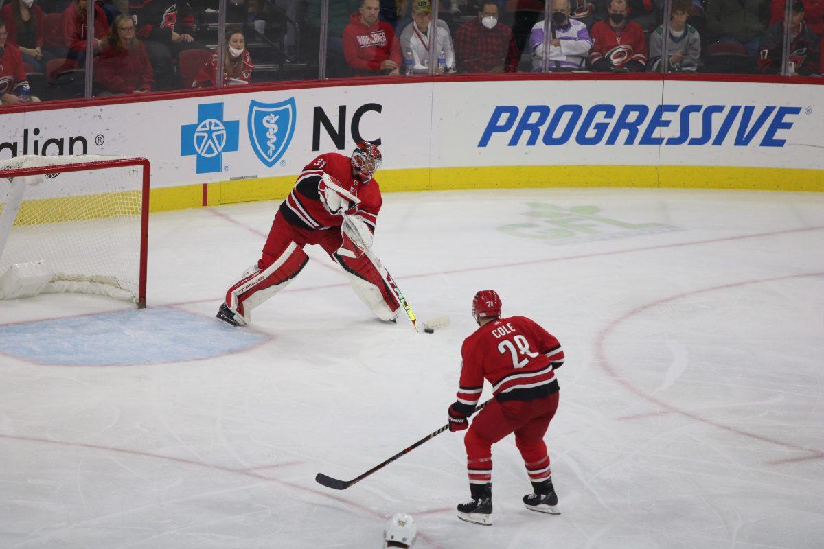 Goaltender Frederik Andersen passes the puck to defenseman Ian Cole in PNC Arena on Tuesday, Jan. 25, 2022. The Hurricanes beat the Vegas Golden Knights 4-3 in overtime.