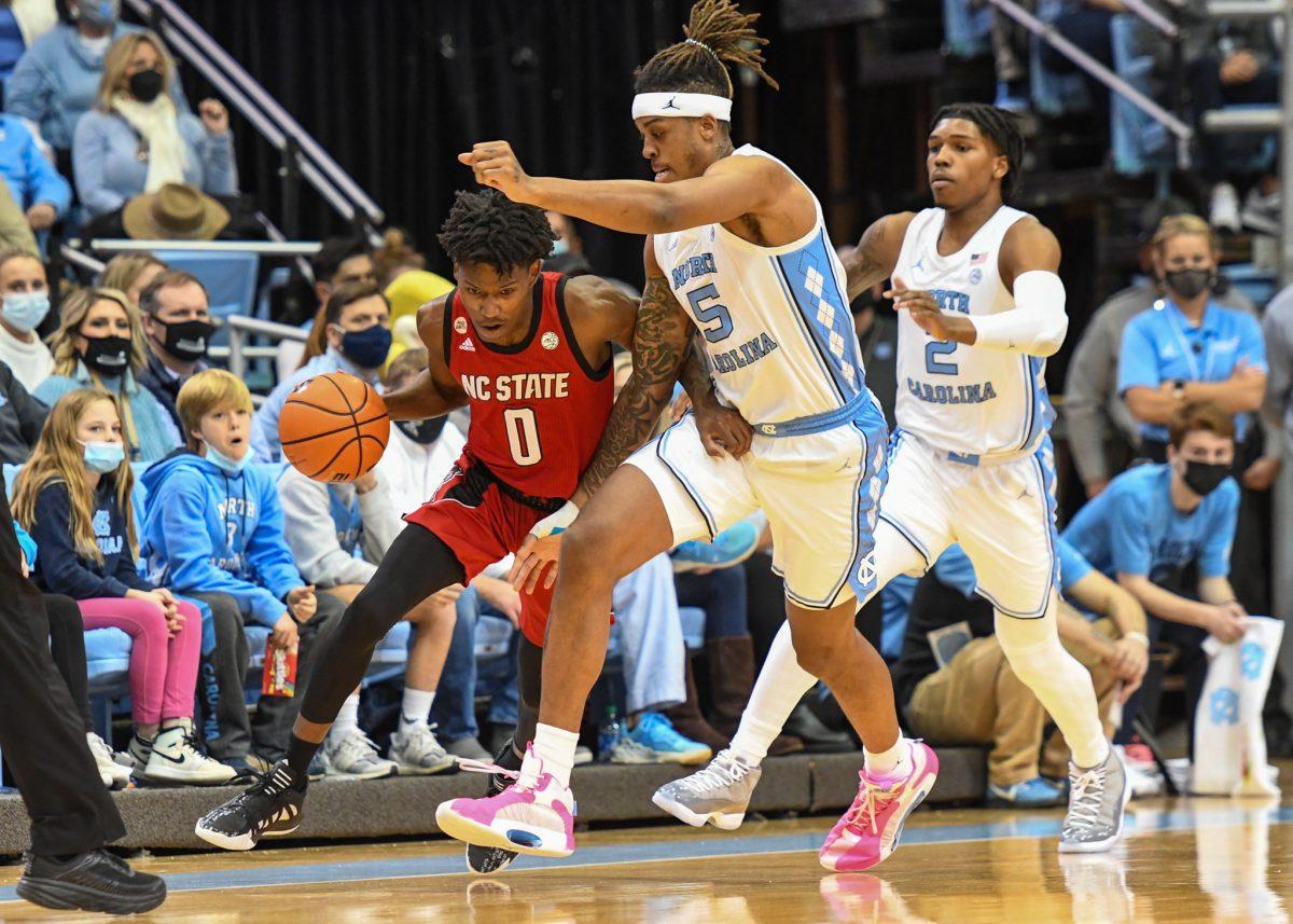 Freshman guard Terquavion Smith attempts to break away from the UNC defense on Saturday, Jan. 29, 2022 in the Dean E. Smith Center. Smith scored a career high of 32 points against UNC. The Wolfpack lost to the Tar Heels 100-80.