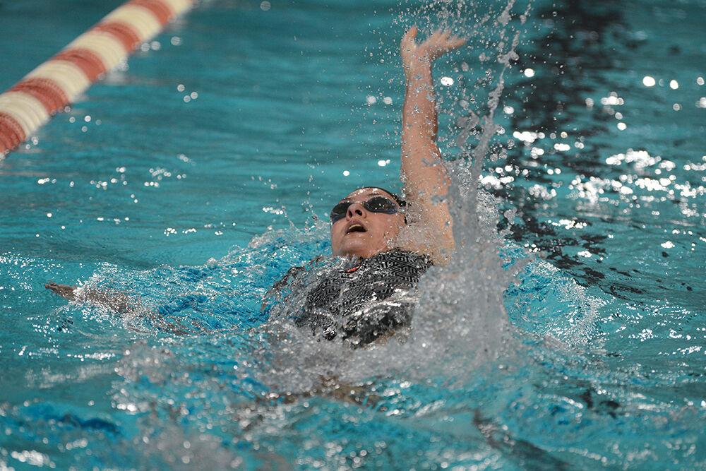NC State senior Emma Muzzy competes 100-yard backstroke during the NC State Wolfpack's swimming and diving meet against the Duke Blue Devils at the Casey Aquatic Center on Saturday, Jan. 15, 2022.&#160;The Pack women beat the Blue Devils 139-87.