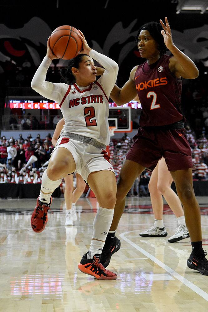 Graduate guard Raina Perez passes the ball to a teammate during NC State&#8217;s game against Virginia Tech on Sunday, Jan. 23, 2022 at Reynolds Coliseum. The Wolfpack beat the Hokies 51-45.