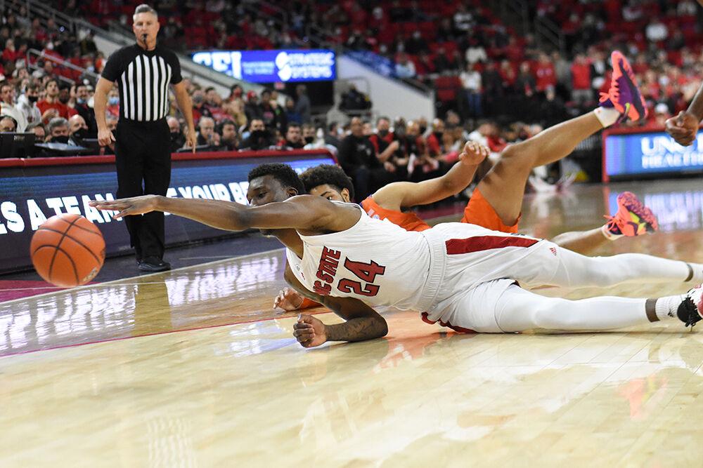 Freshman forward Ernest Ross reaches out to take possession of the ball in the game against Clemson on Saturday, Jan. 8, 2022&#160;in PNC Arena. NC State lost 70-65.