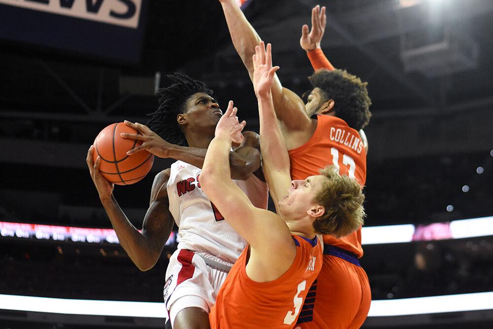 Redshirt sophomore guard Dereon Seabron pushes past defenders and goes for a layup in the game against Clemson Saturday, Jan. 8, 2022 in PNC Arena. Seabron scored 27 points in the game. NC State lost 70-65.