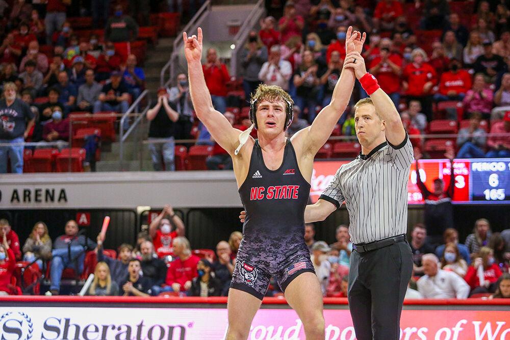 Graduate Thomas Bullard, No. 21 in the 165 weight class, waves to the fans after the 4-1 decision over No. 17 Justin McCoy during the 32-2 win over Virginia on Friday, Feb. 04, 2022 in Reynolds Coliseum.