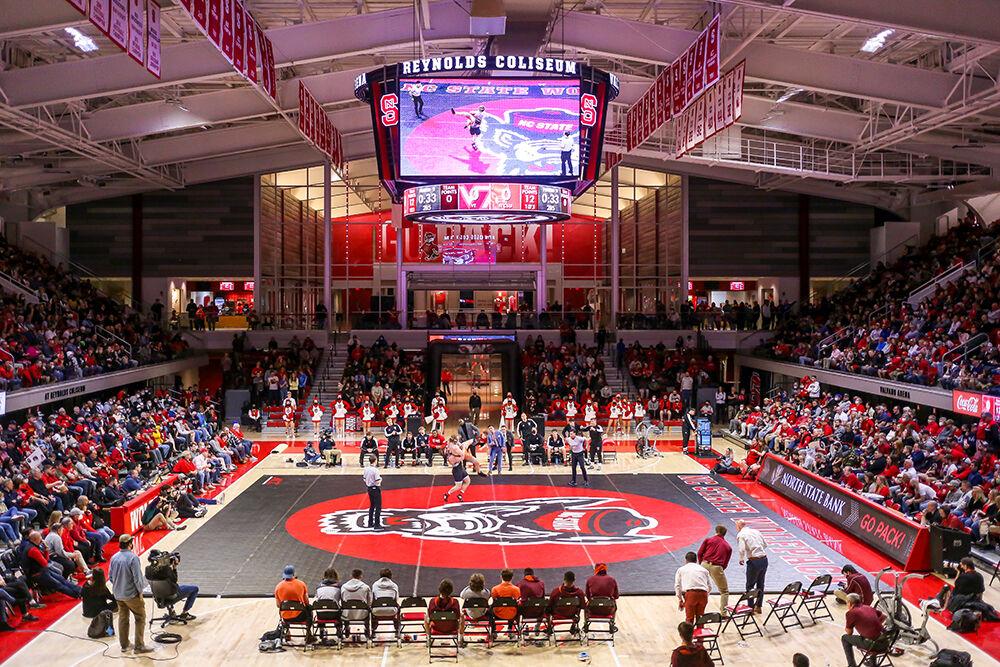 Redshirt freshman Owen Trephan lifts Virginia Tech's Nathan Traxler to maintain control as the crowd cheers. NC State beat Virginia Tech 21-10 in a wrestling meet in Reynolds Coliseum on Sunday, Feb. 20, 2022, securing the ACC dual championship. Trephan lost his match 3-2 to the 14th-ranked Trephan.