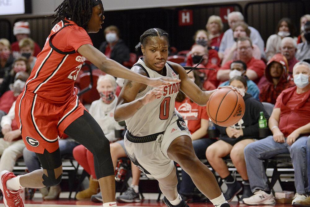 Sophomore guard Diamond Johnson dribbles past a Georgia defender on Thursday, Dec. 16, 2021 at Reynolds Coliseum. Johnson put up 17 points during the game. NC State lost to Georgia 82-80.