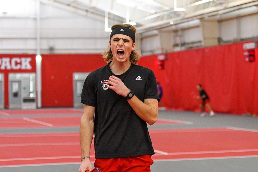 Junior Robin Catry celebrates a point in his singles match against Presbyterian College player Javier Matos on Saturday, Feb. 12, 2022 inside the J.W. Isenhour Tennis Center. Catry won both of his singles matches with scores of 6-0 and 6-3. NC State beat the visiting Presbyterian College 7-0.