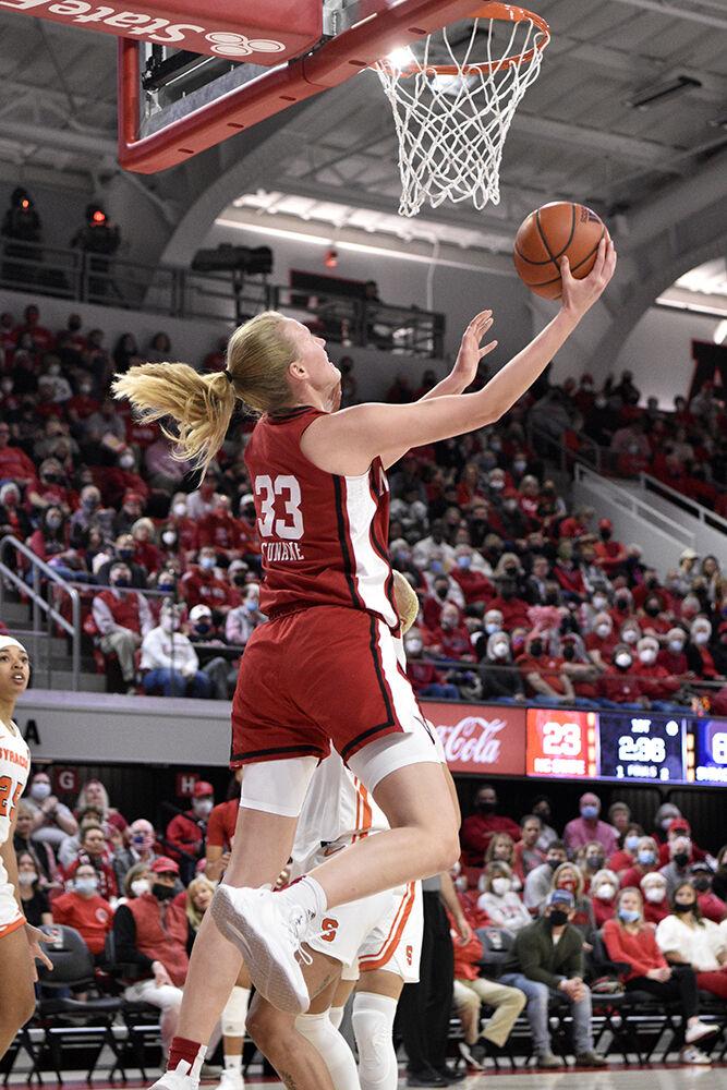 Senior center Elissa Cunane rebounds the ball and puts up a shot against Syracuse during the senior day game on Sunday, Feb. 20, 2022 at Reynolds Coliseum. NC State won against Syracuse 95-53.