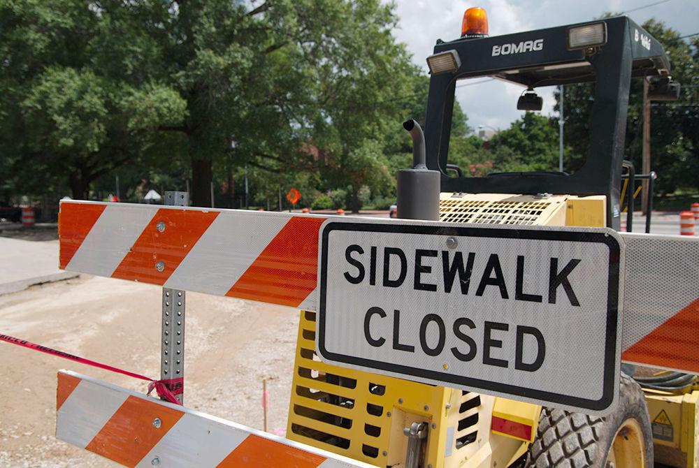 A sidewalk closed sign sits in front of a compactor tells pedestrians to use alternate paths to avoid the construction on Hillsborough Street across from D.H. Hill Library on Wednesday, July 5. The ongoing construction on Hillsborough Street means that pedestrians must find their way along the road through alternate paths to avoid the work areas which contain dangerous machinery. The construction has also caused problems with traffic coming in and out of Raleigh.