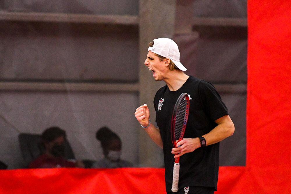 Junior Robin Catry celebrates a point in his singles match against Boston College player Max Motlagh on Sunday, Feb. 27, 2022 at J.W. Isenhour Tennis Center. Catry won his first singles match and the tie-breaking match with scores of 6-3 and 1-0. The Wolfpack won the match versus the Eagles 7-0.