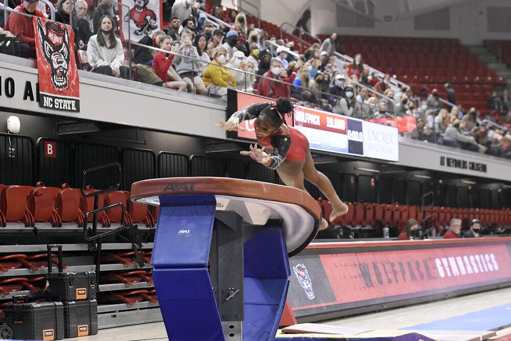Sophomore gymnast Madison Benson mounts the vaulting table at NC State&#8217;s meet against UNC on Saturday, Feb. 19, 2022 at Reynolds Coliseum. NC State lost to UNC 196.625 to 196.350.