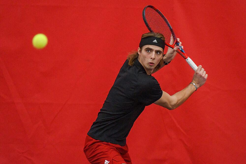 Junior Robin Catry prepares to make a backhand swing in his singles match against Presbyterian College player Javier Matos on Saturday, Feb. 12, 2022 inside the J.W. Isenhour Tennis Center. Catry won both of his singles matches with scores of 6-0 and 6-3. The Wolfpack pulled a win over the Blue Hose with a score of 7-0.