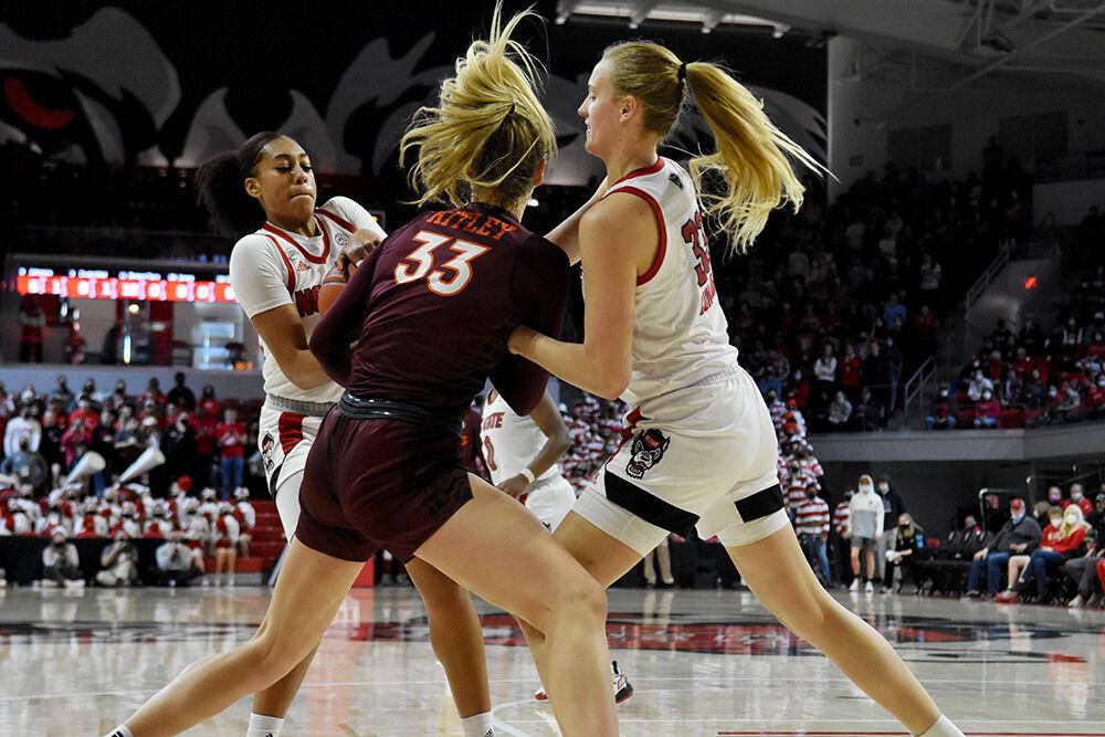 Junior wing Jakia Brown-Turner and senior center Elissa Cunane fight for the ball against Virginia Tech at Reynolds Coliseum on Sunday, Jan. 23, 2022. Brown-Turner had a combined 17 rebounds during the game. The Wolfpack beat the Hokies 51-45.