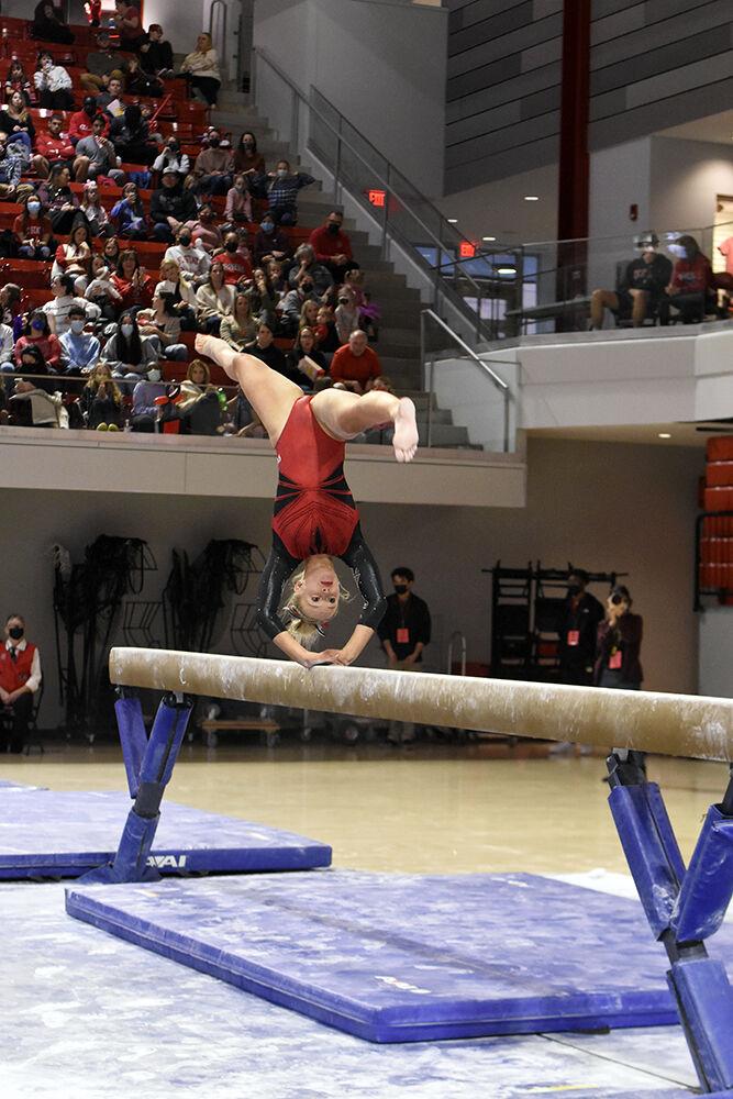 Freshman gymnast Brooke Smead does a back handspring on the balance beam at the meet against UNC on Saturday, Feb. 19, 2022 at Reynolds Coliseum. The Wolfpack lost to the Tar Heels 196.625 to 196.350.
