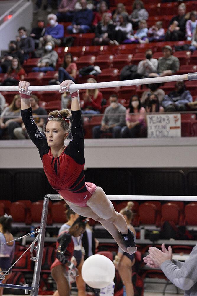 Senior gymnast Meredith Robinson performs on uneven bars at the meet against UNC at Reynolds Coliseum on Saturday, Feb. 19, 2022. NC State lost to UNC 196.625 to 196.350.