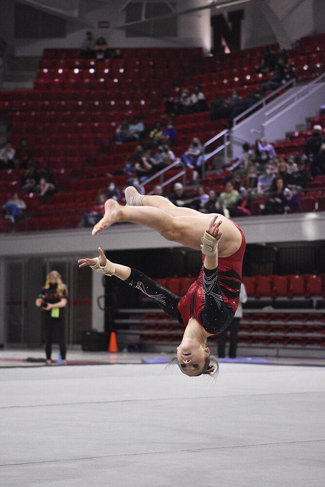 Freshman gymnast Lauren Rutherford completes a tumbling pass at the meet against UNC at Reynolds Coliseum on Saturday, Feb. 19, 2022. NC State lost to UNC 196.625 to 196.350.