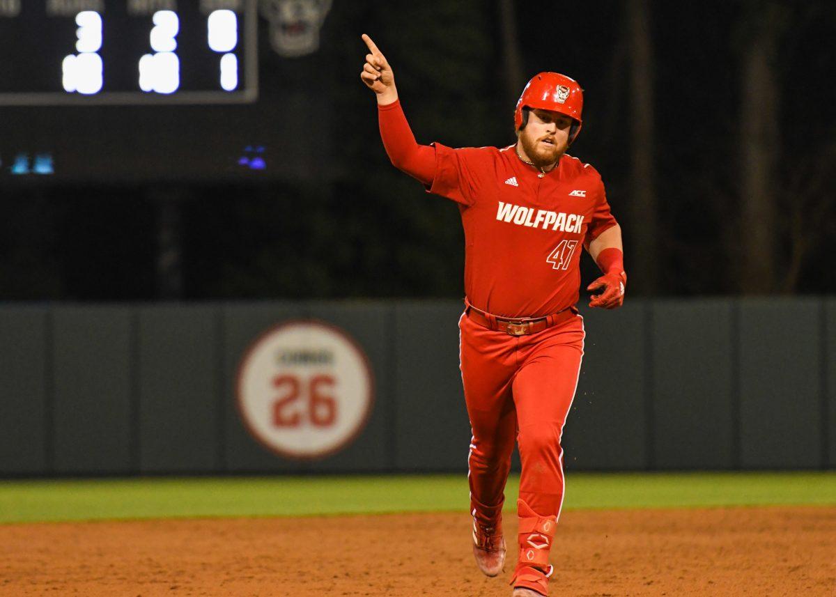 Freshman infielder Tommy White points to his fans after hitting a home run during the game versus Quinnipiac on Friday, Feb. 25, 2022 in Doak Field at Dail Park. The Wolfpack beat Quinnipiac 10-4.
