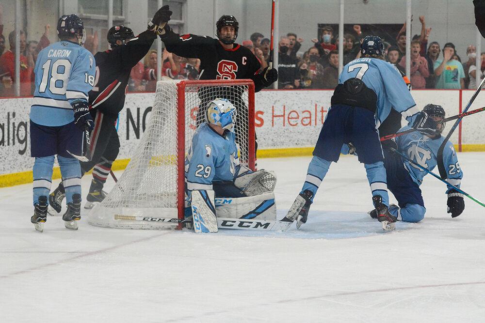 Junior forward Matt Miller and junior forward Chris Solomon high-five as they celebrate their goal against the Tar Heels. The Icepack defeated the UNC Tar Heels 10-3 in its first hockey match of the season at Wake Competition Center on Friday, Sept. 17, 2021.