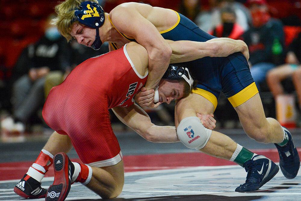 Redshirt freshman Kai Orie shoots for a takedown during the NC State match against West Virginia on Sunday, November 21, 2021 in Reynolds Coliseum. Orine won his individual match against the Mountaineers 4-1.&#160;The Pack beat the Mountaineers 34-6.