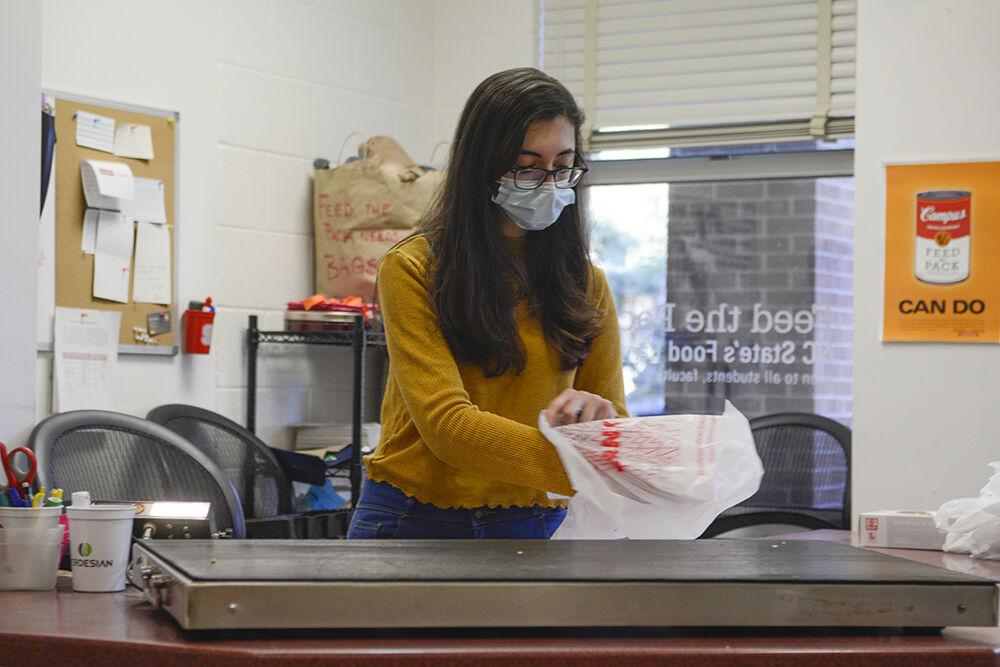 Tara Esmailian, a third-year majoring in nutrition science, volunteers and bags food items at Feed the Pack food pantry in Quad Commons on Wednesday, Feb. 9, 2022.