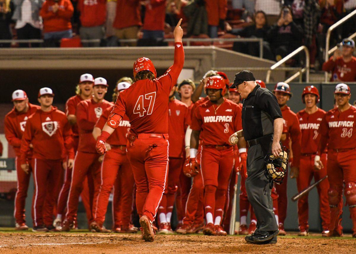 Freshman infielder Tommy White celebrates his grand slam hit during the game versus Quinnipiac on Friday, Feb. 25, 2022 in Doak Field at Dail Park. The Wolfpack beat Quinnipiac 10-4.