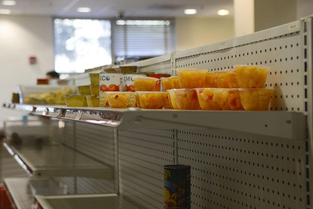 Cups of fruit sit on shelves at Feed the Pack food pantry in Quad Commons on Wednesday, Feb. 9, 2022.