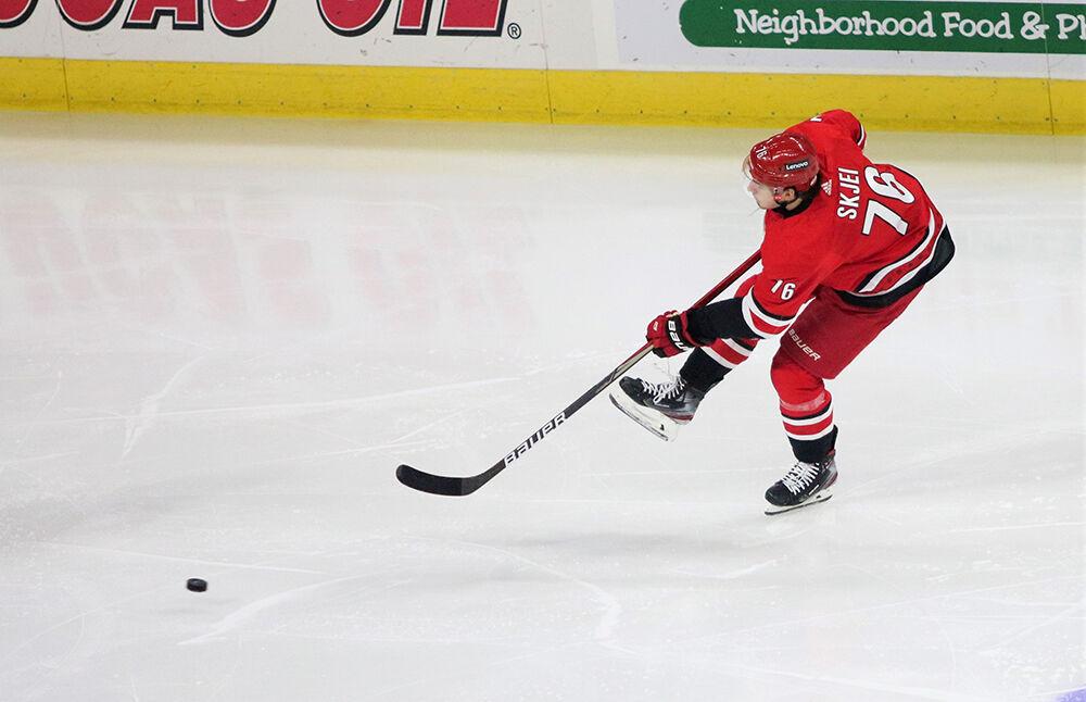 Left defenseman Brady Skjei hits the puck in attempt to score a goal in PNC Arena on Tuesday, Jan. 25, 2022. Skjei had four shots in 24 shifts. The Hurricanes beat the Vegas Golden Knights 4-3.