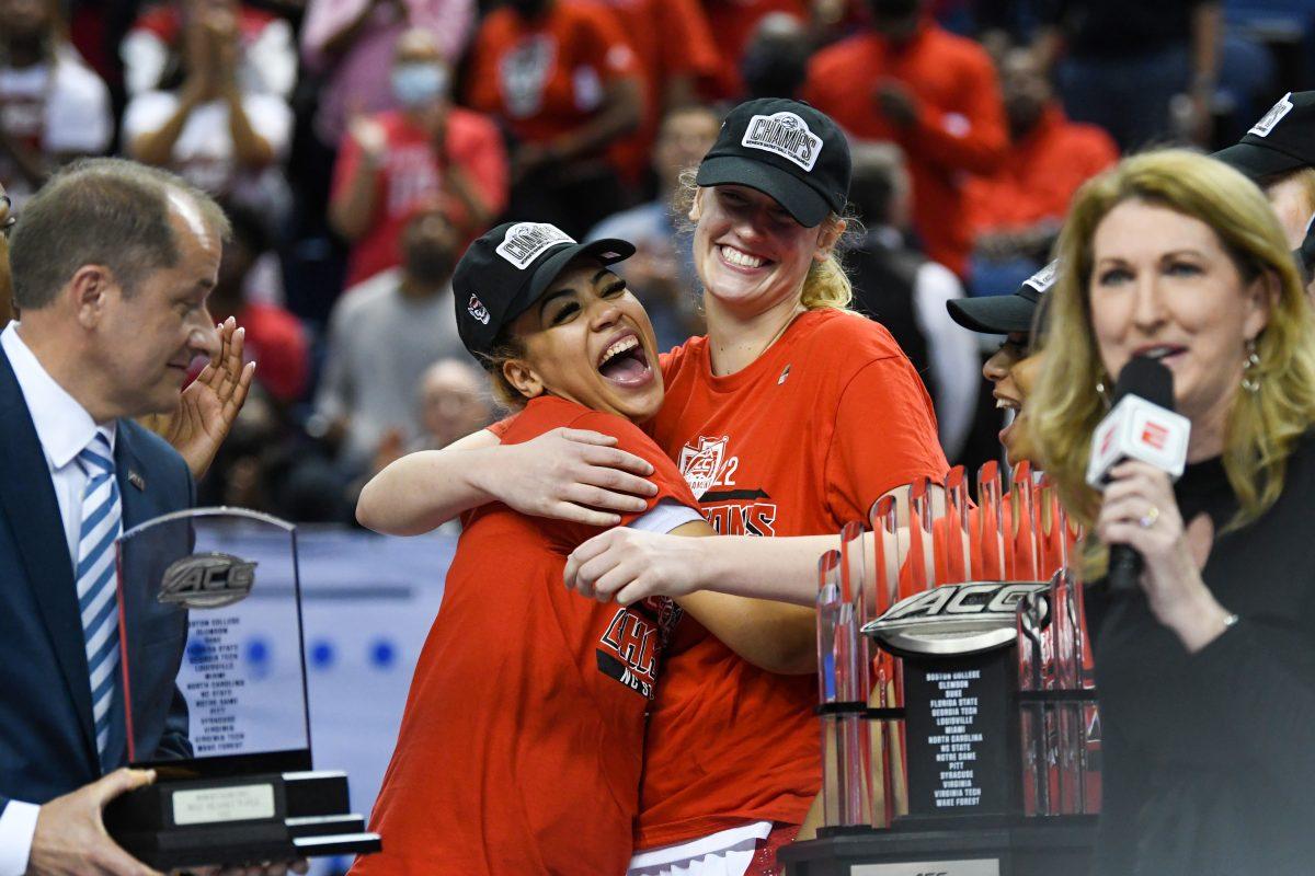 Senior center Elissa Cunane hugs sophomore guard Madison Hayes after the ACC championship game against the University of Miami on Sunday, March 6, 2022 inside Greensboro Coliseum. NC State won the game 60-47.