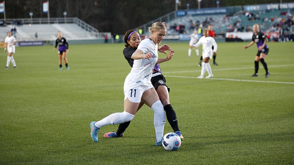 NC Courage defender Merritt Mathias works the ball around an Orlando Pride defender during the preseason match in Sahlen&#8217;s Stadium at WakeMed Soccer Park on Saturday, March 26, 2022. Mathias took a penalty kick in the second half and NC Courage beat Orlando Pride 1-0.