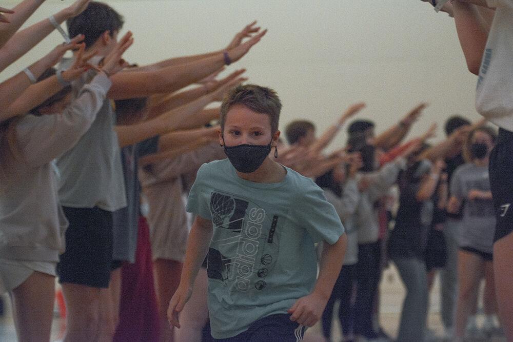 Connor Brienzi, a cancer survivor from Duke Children's Hospital, runs througnh the crowd in Talley Student Union during the Dance Marathon on Saturday, March 5, 2022. This event is a fundraiser for Duke Children's Hospital where participants dance to raise money.