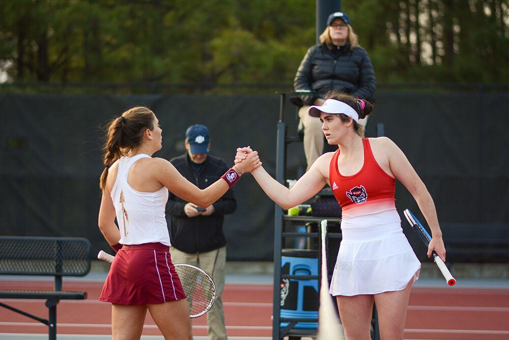Senior Nell Miller shakes hands after defeating her opponent during the match against Florida State University at Dail Outoor Tennis Center on Friday, March 4, 2022. Miller won her singles match 2-0 and the Wolfpack beat the Seminoles 6-1.