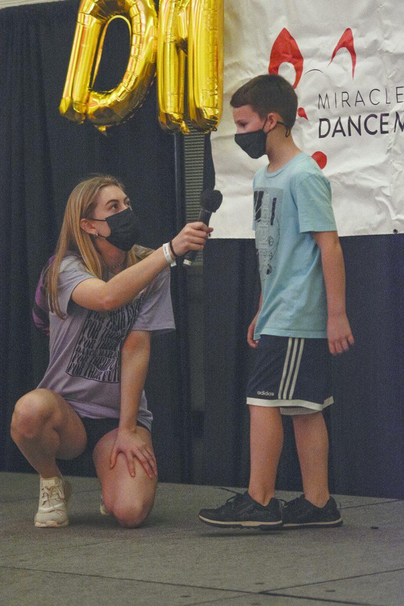 Olivia Holbrook, a second-year in environmental engineering, helps Connor Brienzi, a cancer survivor, share his story in Talley Student Union during the Dance Marathon on Saturday, March 5, 2022. This event is a fundraiser for Duke Children's Hospital where participants dance to raise money.
