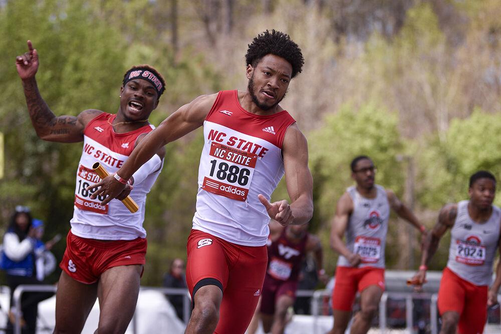 Graduate sprinter Von Douglas hands off the baton to senior sprinter Alan Alvarez during the 4x100m relay event of Raleigh Relays on March 26, 2022 at Paul Deer Track &amp; Field facility. NC State's 4x100m relay team placed third overall with a time of 40.60.