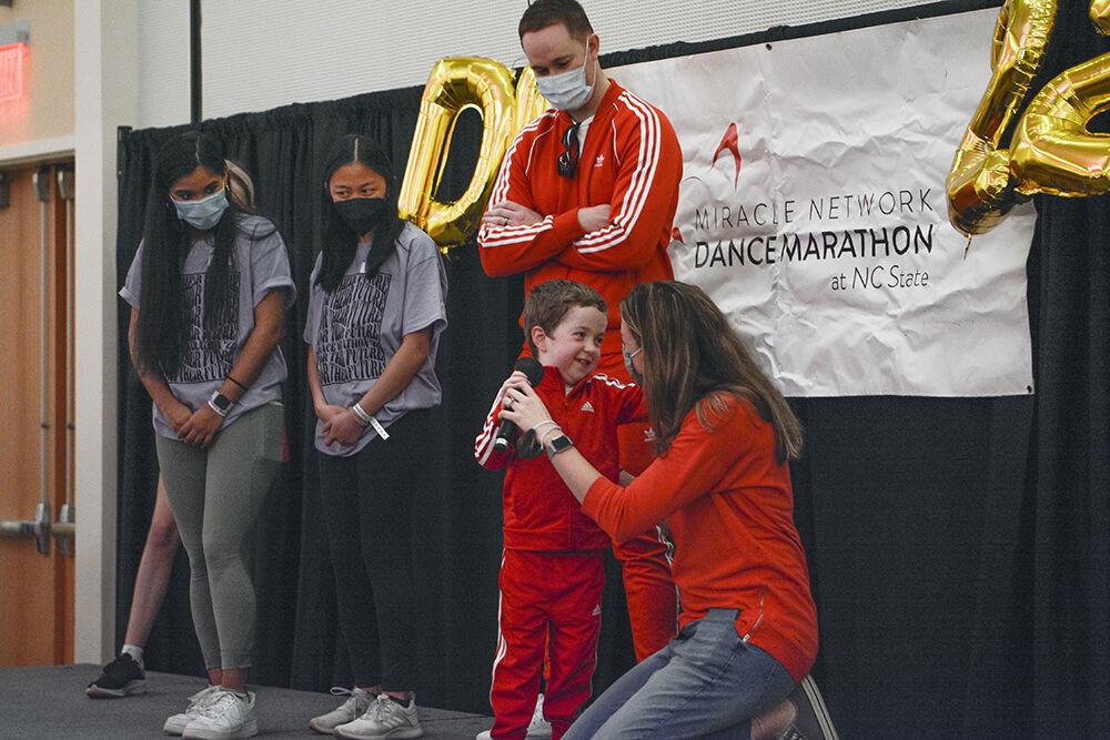 Braeden Deaver, a Duke Children's Hospital patient, shares his story about Hypoplastic Left Heart Syndrome with the help of parents Stephanie and Jeremy Deaver and volunteers Shivani Desai, a second-year in human biology, and Dani Smith, a third-year in animal science, in Talley Student Union during the Dance Marathon on Saturday, March 5, 2022. This event is a fundraiser for Duke Children's Hospital where participants dance to raise money.