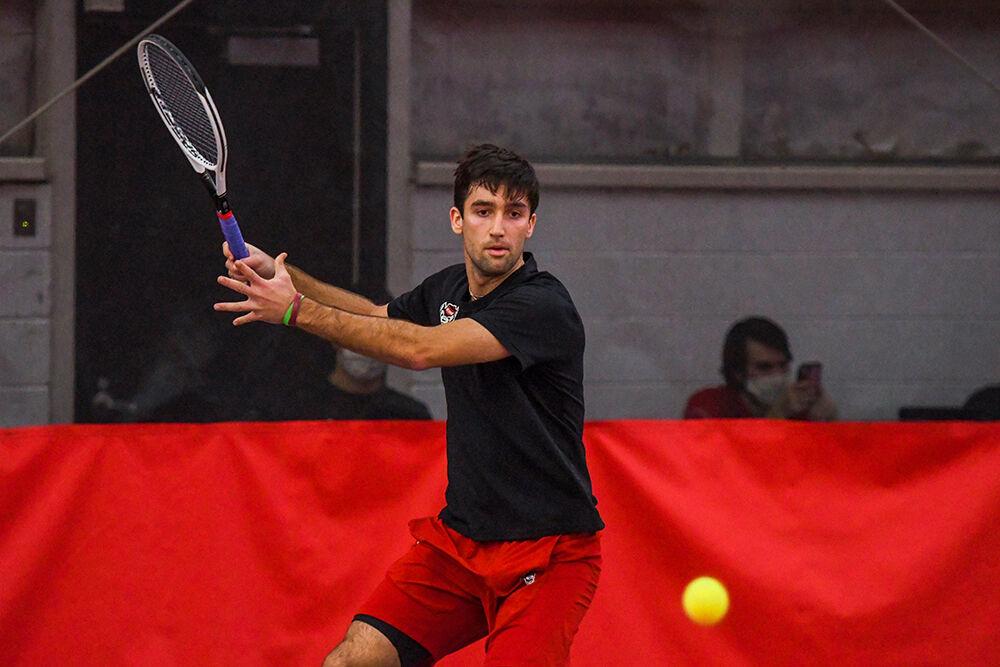 Senior Rafa Izquierdo Luque gets ready to make a forehand swing during his singles match against Presbyterian College player Max Benson on Saturday, Feb. 12, 2022 inside the J.W. Isenhour Tennis Center. Izquierdo Luque won both his singles matches with scores of 7-5 and 6-2. The NC State Wolfpack beat the Presbyterian College Blue Hose 7-0.