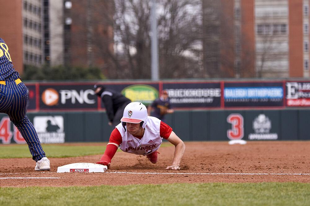 Freshman catcher Jacob Cozart dives for first base during the game against Quinnipiac on Saturday, Feb. 26, 2022 in Doak Field at Dail Park. The Wolfpack beat the Bobcats 12-10 to win the series.