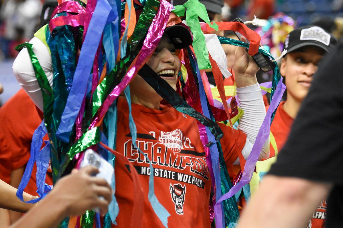 Graduate guard Raina Perez is decorated with confetti after the Wolfpack win over the Miami Hurricanes in the championship game of the Women's ACC Tournament on Sunday, March 6, 2022 in the Greensboro Coliseum. Perez scored 12 points against Miami. The Wolfpack beat the Hurricanes 60-47.