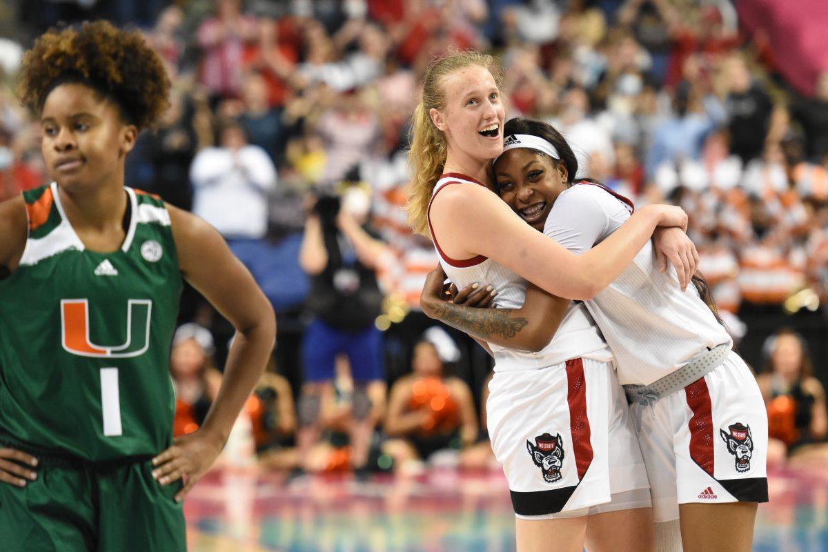 Senior center Elissa Cunane and junior forward Jada Boyd hug as the buzzer sounds after the championship game of the Women's ACC Tournament versus Miami on Sunday, March 6, 2022 in the Greensboro Coliseum. This is the third consecutive ACC Tournament title for the Wolfpack under head coach Wes Moore. The Wolfpack beat Miami 60-47.