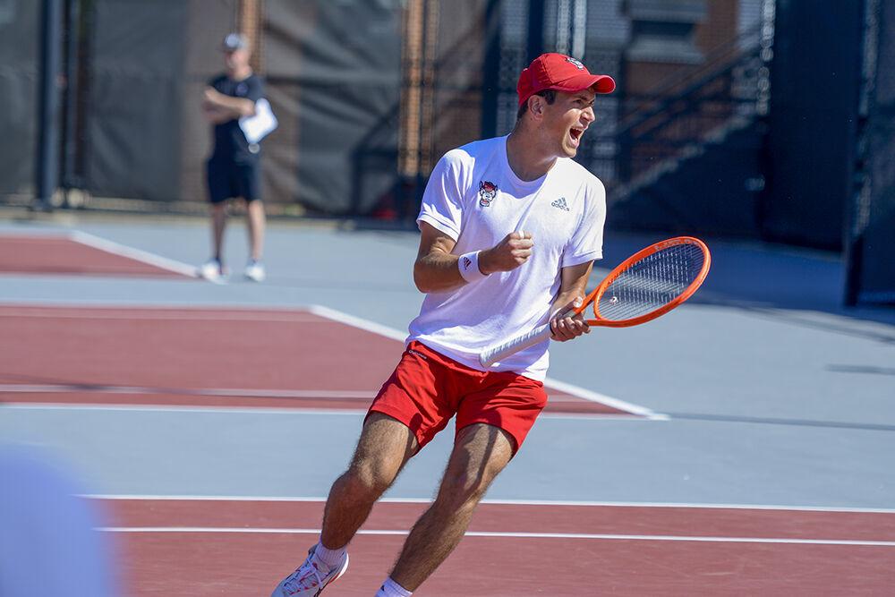 Sophomore Luca Staeheli celebrates during his singles match against Northeastern on Monday, March 21, 2022 at the J.W. Isenhour Tennis Center. Staheli won his singles match with the Wolfpack beating the Huskies 4-2.