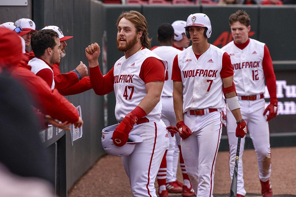 Freshman infielder Tommy White celebrates with his teammates during the Wolfpack's home baseball game at Doak Field against the Quinnipiac Bobcats on Feb. 26, 2022. The Wolfpack won 12-10 in extra innings. White had one homerun on three hits against the Bobcats.