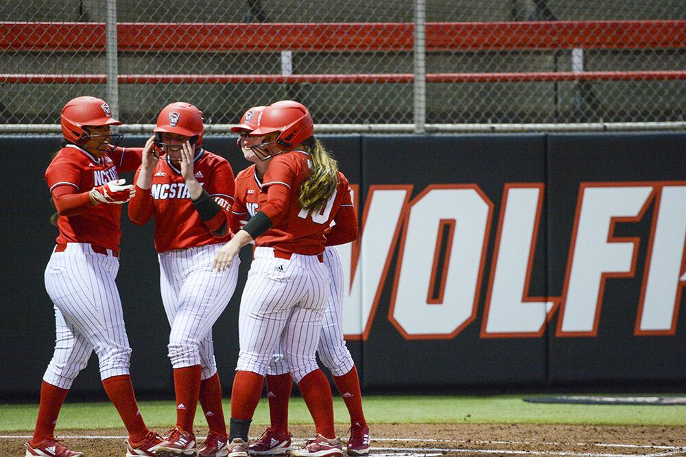 The NC State Softball team celebrates after scoring two home runs during the game against Syracuse on Friday, March 4, 2022 in Dail Softball Stadium. The Wolfpack beat the Orange 8-2.