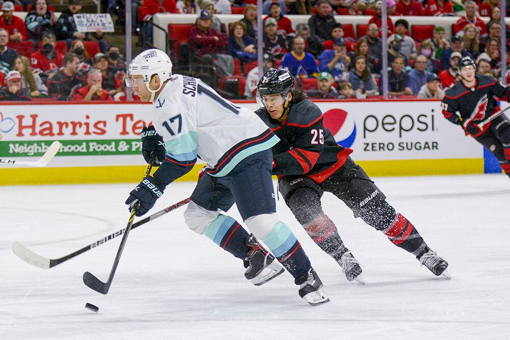 Carolina Hurricanes defenseman Ethan Bear tries to steal the puck during the game against the Seattle Kraken on Sunday, March 6, 2022 in PNC Arena. Bear had 23 shifts. The Hurricanes beat the Kraken 3-2.