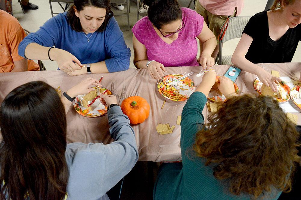 Members of the NC State chapter of Hillel build dessert sukkah during their Sukkot celebration on Tuesday, Oct. 3, 2017 in their club room above Hillsborough St. Sukkot is a Jewish holiday where people build booths and sleep in them for seven days to commemorate the forty-year period the Jewish people wandered in the desert.