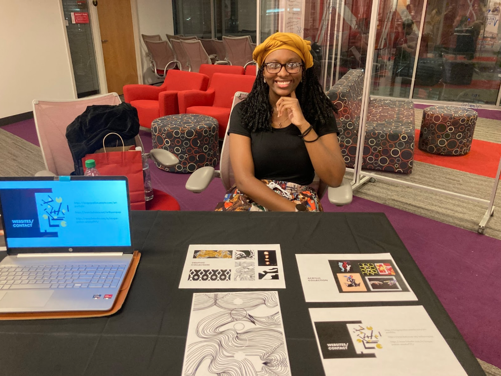 Unique Patton, a third-year studying design presents her abstract art at the Visual Arts Expo in Talley Student Union on March 3, 2022. The Visual Arts Expo is a program that provides artists with an opportunity to showcase their work and network with other students.
