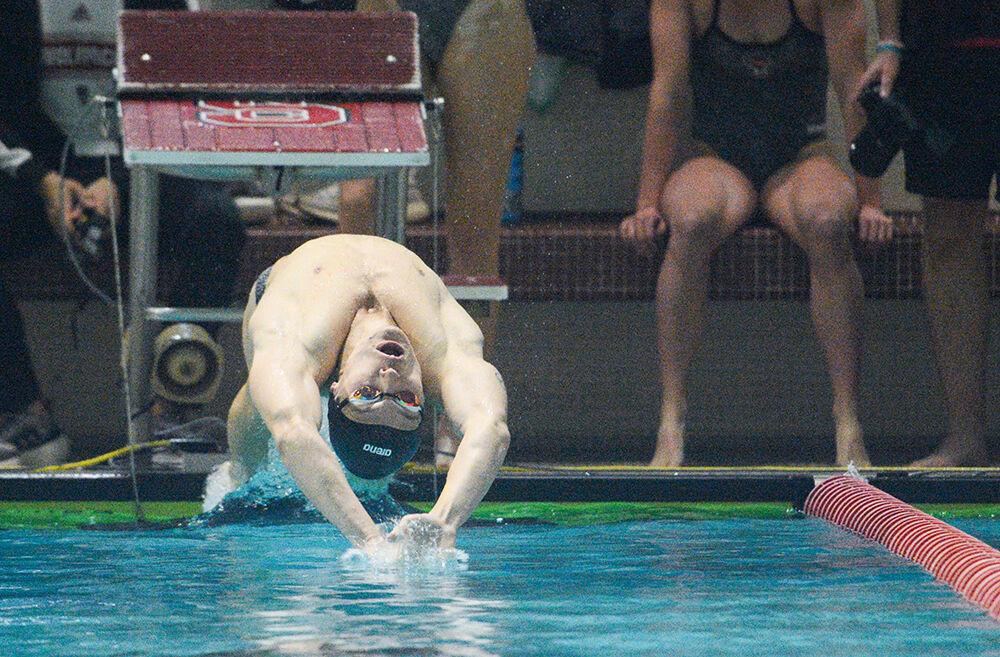 Junior Kacper Stokowski enters the water at the start of the 200 backstroke during the meet against Tennessee on Friday, Oct. 15, 2021 in the Willis R. Casey Aquatic Center. Stokowski placed first in this event with a time of 1:43.83. The Wolfpack men's team beat the Volunteers 205-95.